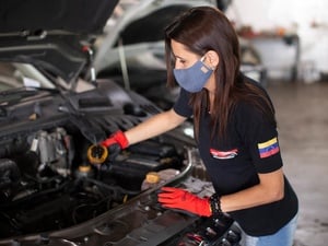 Displaced Venezuelan Samira works as a mechanic in the car repair workshop she runs in Salta, Argentina.