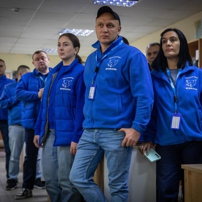 A group of people wearing the same blue vest