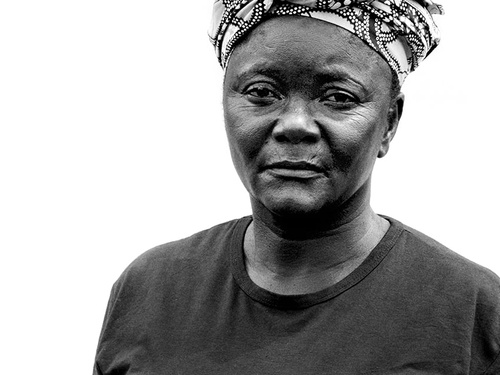 Black-and-white portrait of a Congolese refugee woman facing the camera.