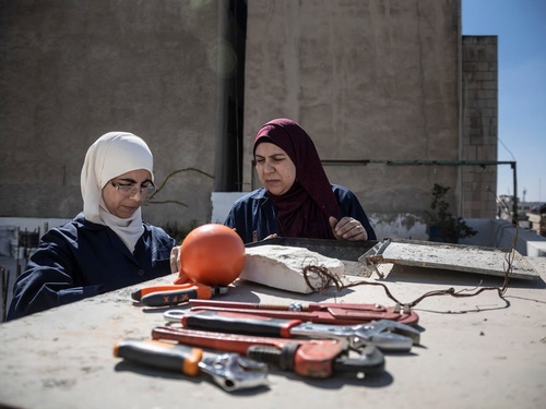 Jordan. Female plumber teaches refugees her trade