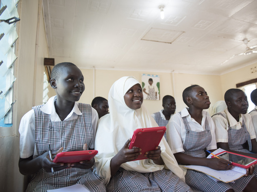 A group of students in a classroom using tablets