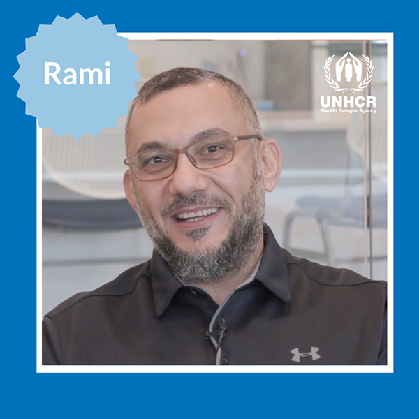 man with wire frame glasses and black polo shirt