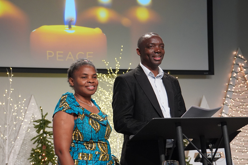 Pastor Gatera and his wife, Appoline, standing at a speaker podium.
