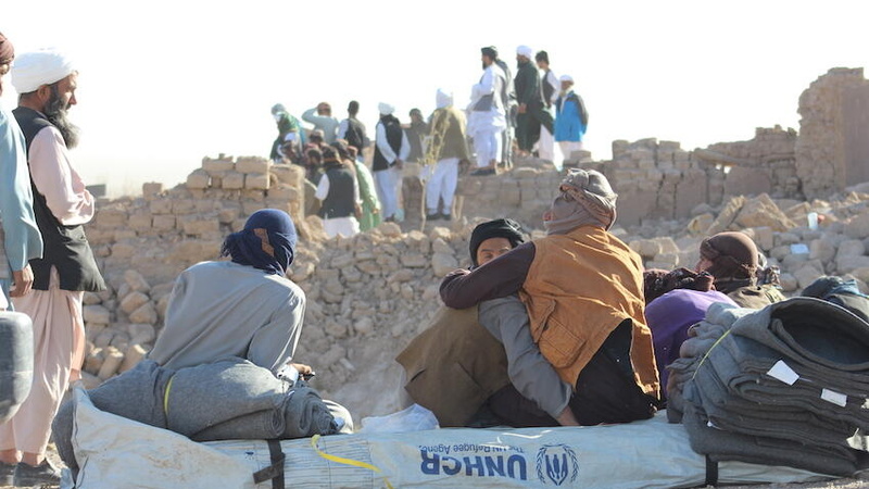 Families facing their destroyed houses while receiving tents and other emergency support from UNHCR Afghanistan after the recent earthquake