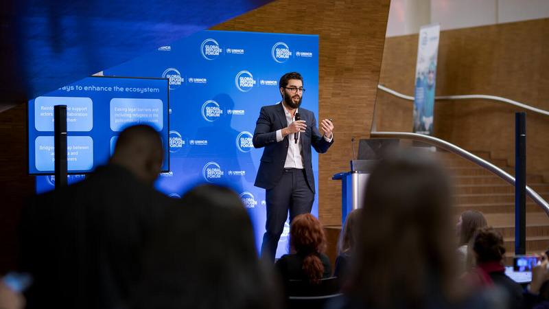 A speaker on the stage in front of a GRF banner