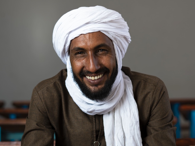 A Malian man smiling at the camera.