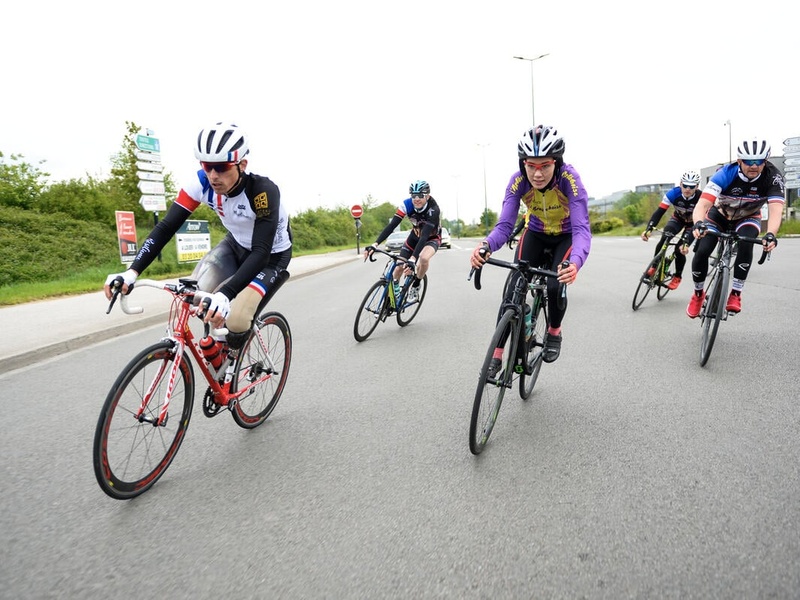 Masomah cycling together with other professional cyclists.