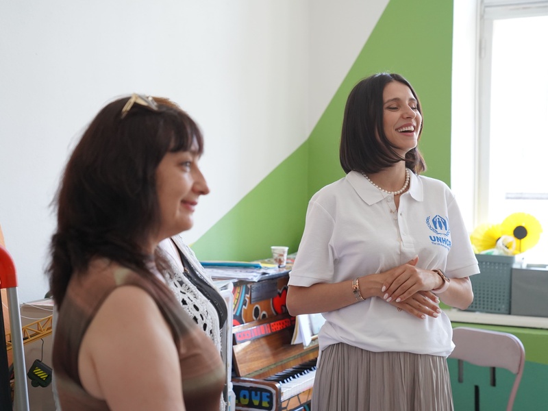 Valentina Naforniță smiling and wearing a white t-shirt with the UNHCR logo