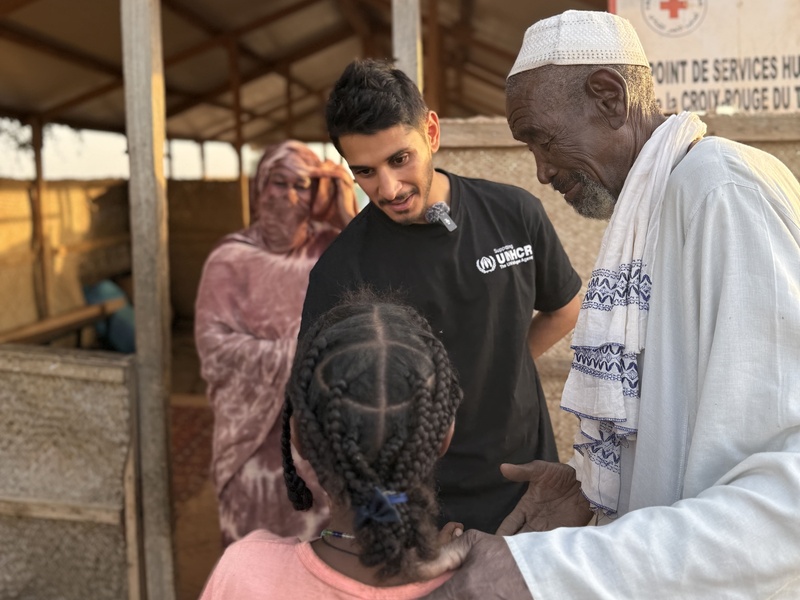 Omar speaks with a young girl and an adult man.