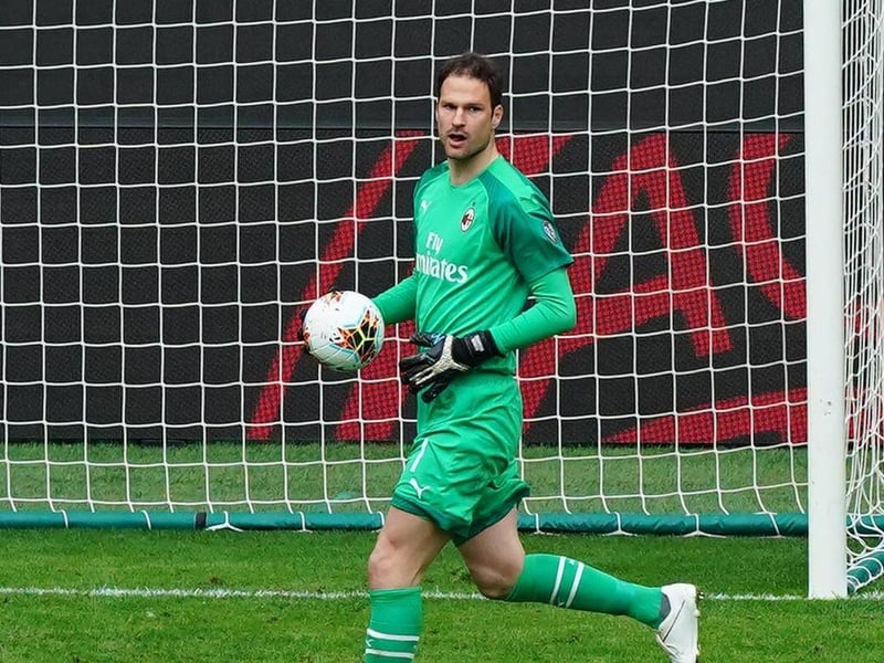 Asmir Begovic holding a football and running in front of the goal