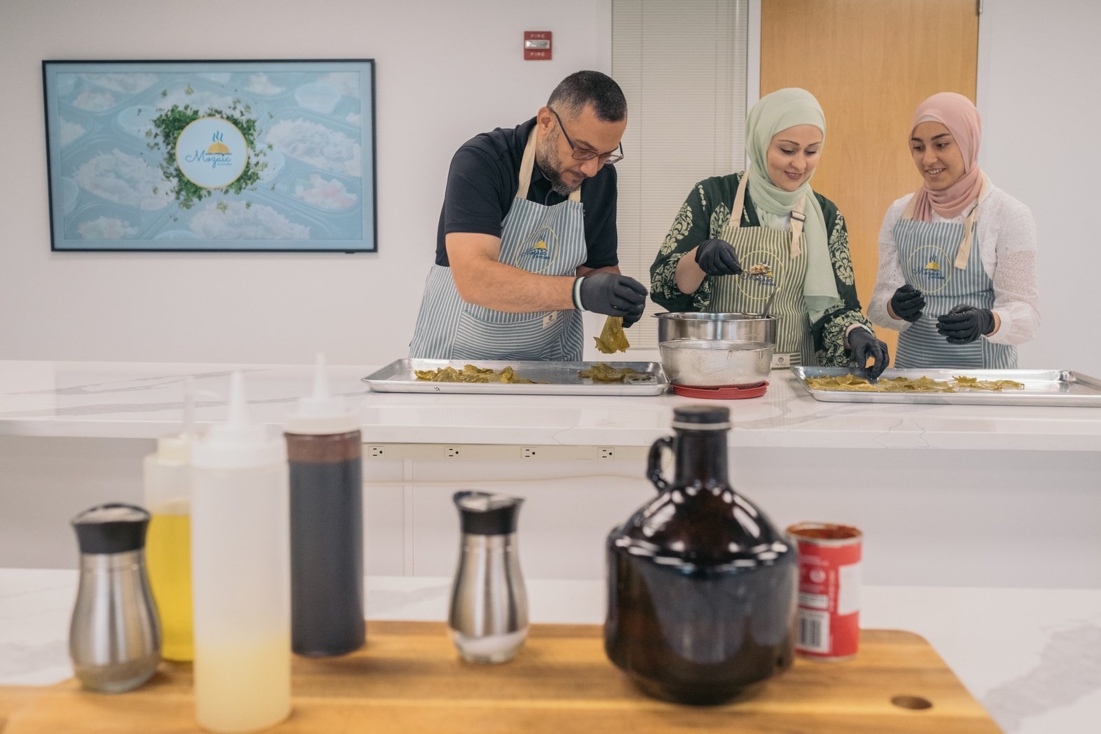 Rami and his family prepare Syrian yalanji in the Mozaic Center kitchen.