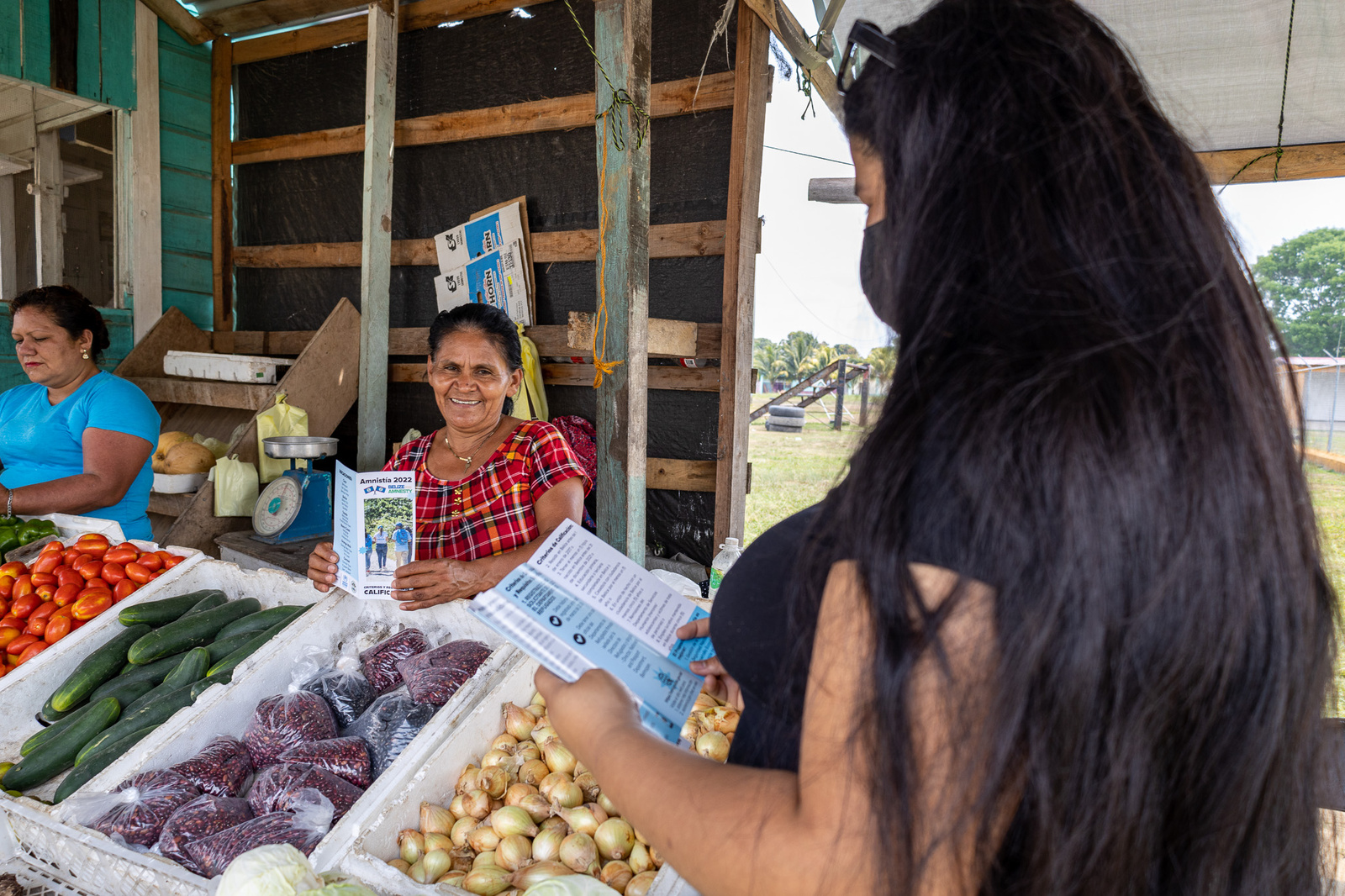 Ada*, a young Honduran asylum-seeker walks in her community of Bella Vista, Belize sharing information on how to apply for the Government of Belize’s amnesty program, an opportunity for asylum-seekers and migrants to apply for permanent residency.