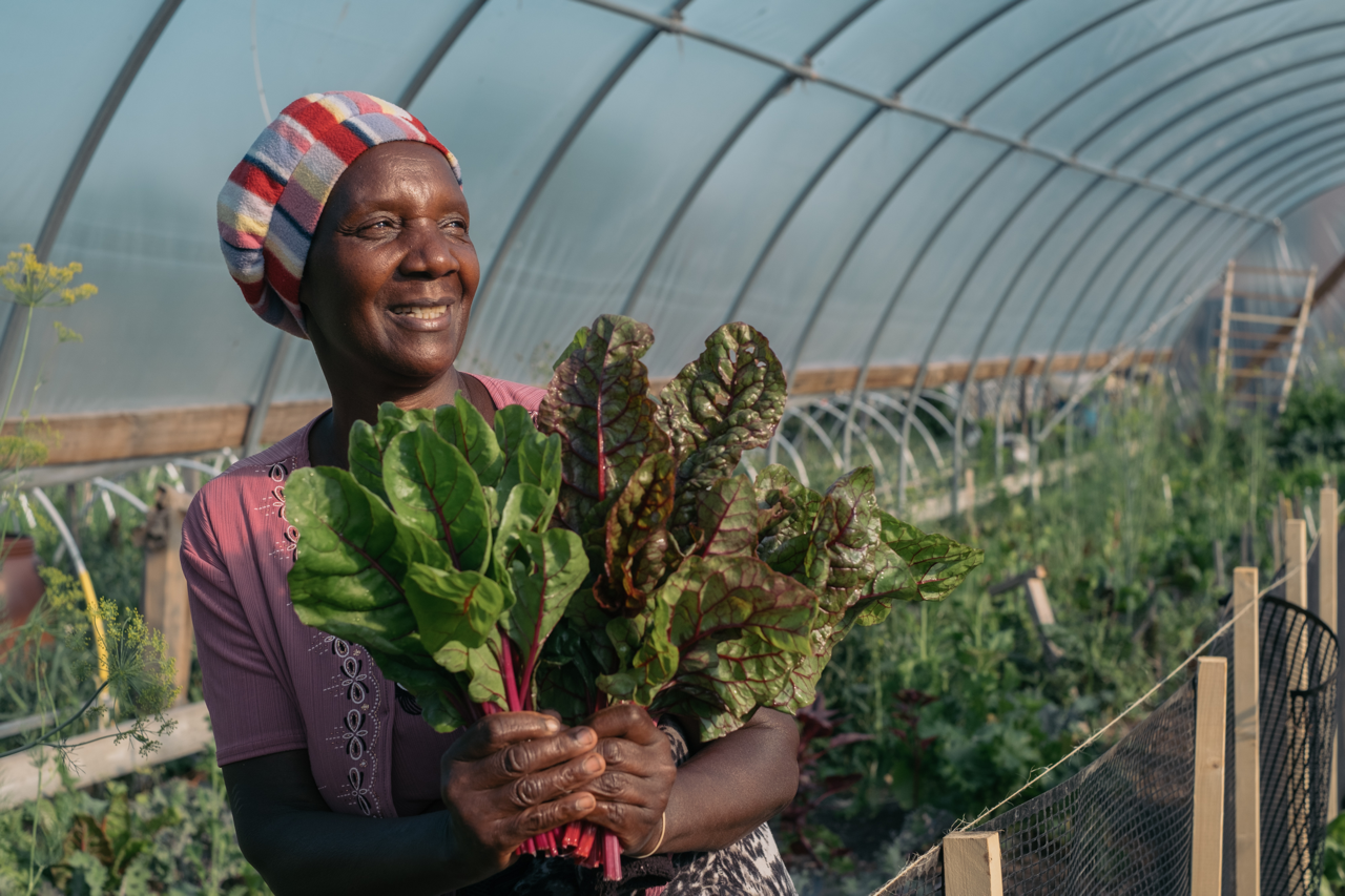 Celestine, a refugee from Burundi, waters her vegetables in her plot at the Global Garden Refugee Training Farm in Chicago, Illinois.