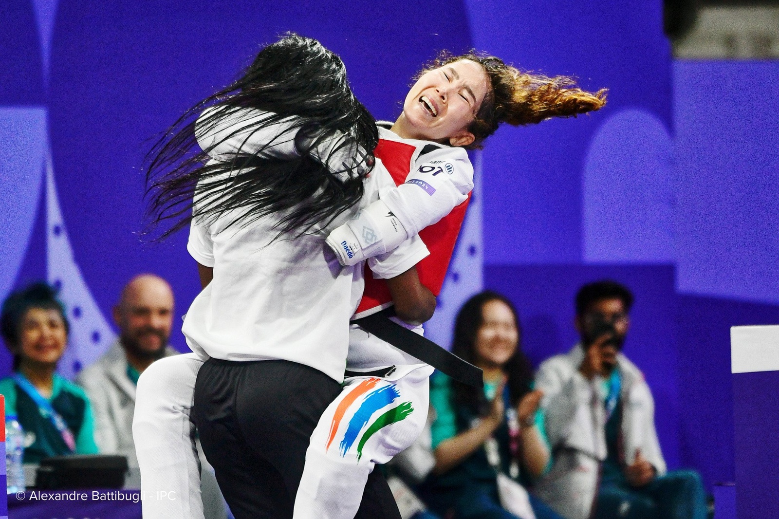 An emotional athlete jumps into the arms of their coach.