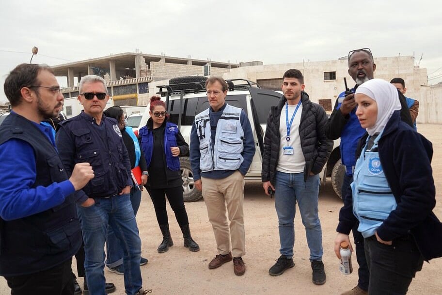 Humanitarian staff stand in a group outside