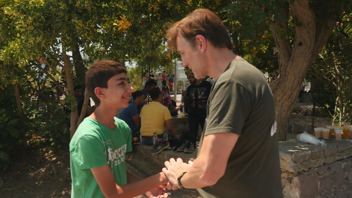 David Morrissey greets a young boy.