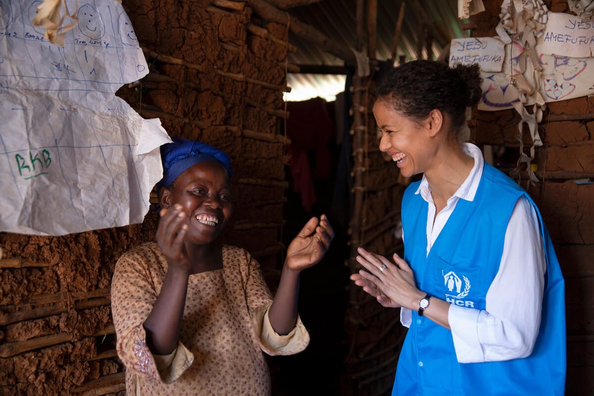 Two women, Gugu Mbatha-Raw and Vicky, laugh together.
