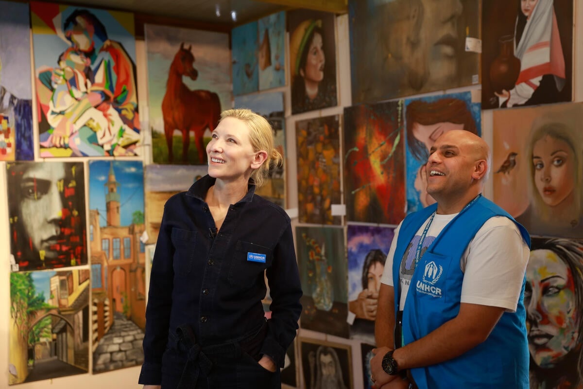 Cate and Omar looking at walls covered in art