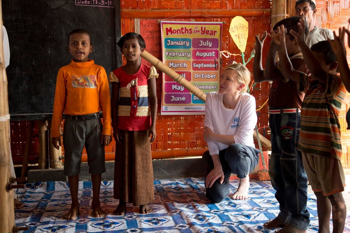Four children perform while Cate and another adult look on. 