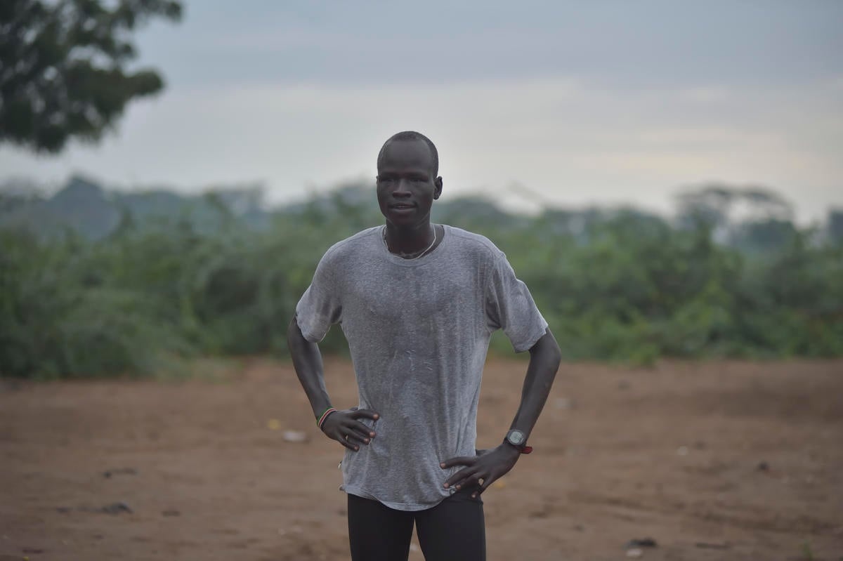 Yiech Pur Biel catches his breath, his hands on his hips.
