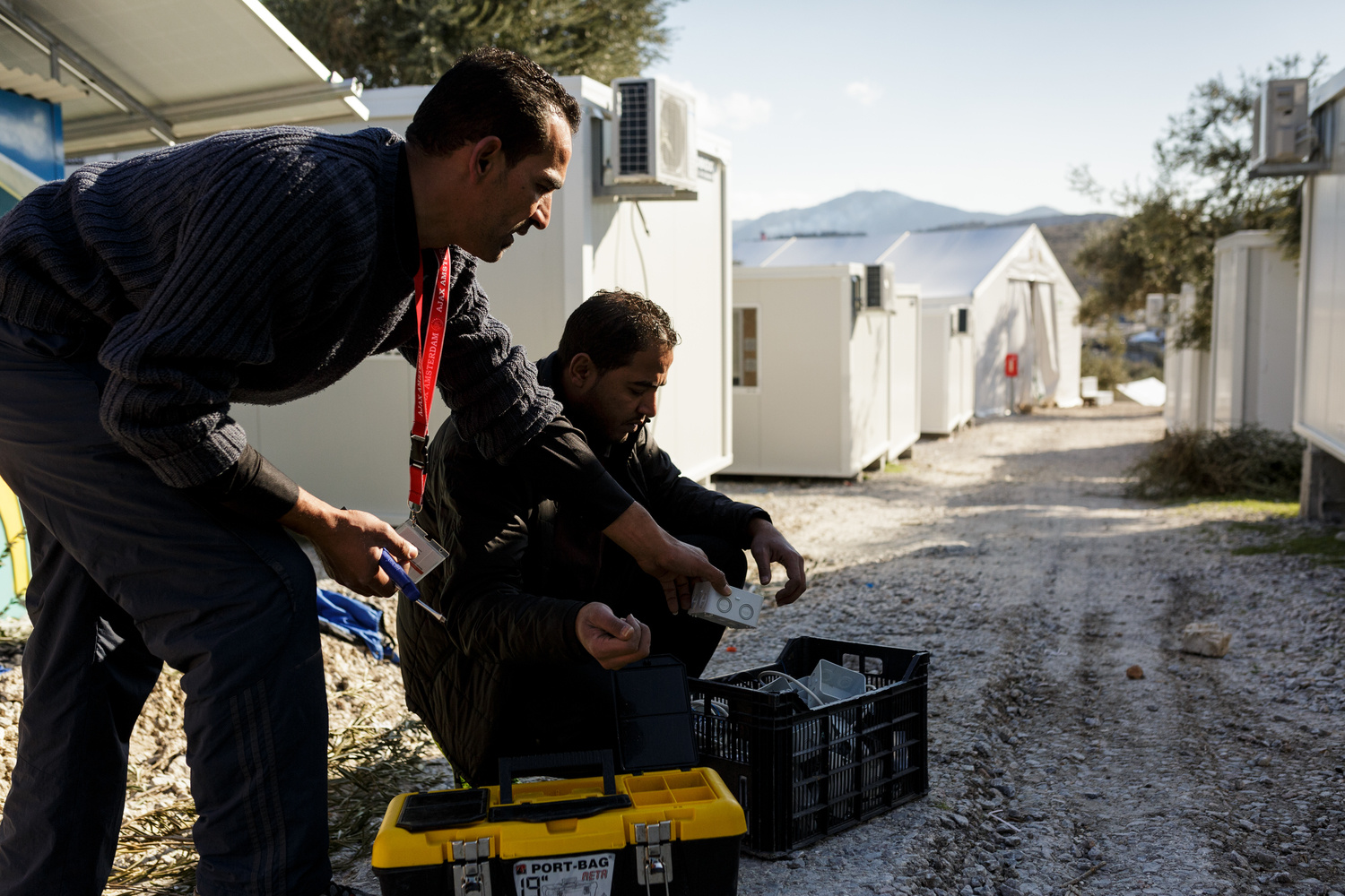 Greece. The Syrian electrician installing power at Lesbos refugee camp