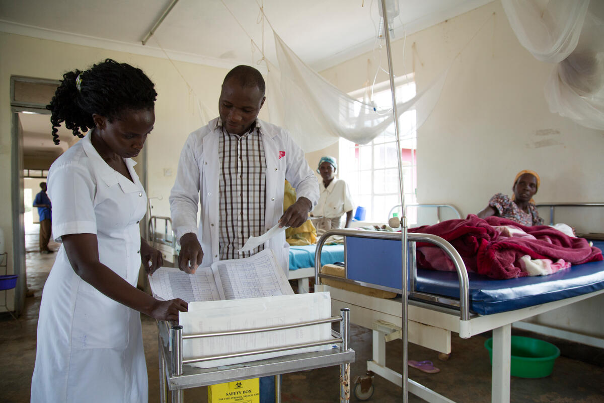 Uganda. Cancer-stricken refugee nurse cares for the sick