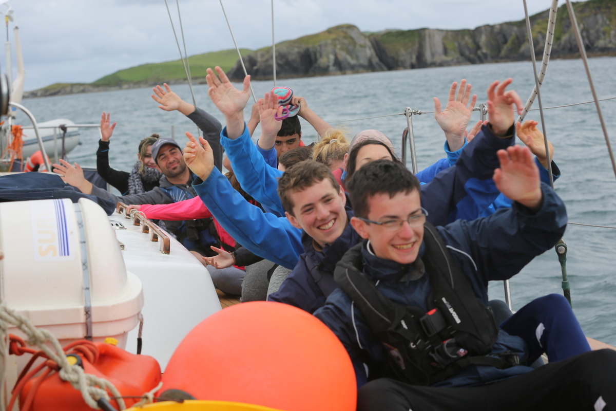 Ireland. Syrian and Irish teenagers having fun on board a yacht