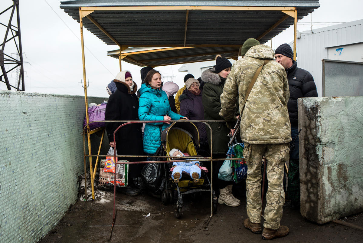 Ukraine. Freedom of movement. People are waiting in a line to cross the border at the crossing checkpoint in Mariinka, as they travel from the government controlled area to the non-government controlled area.