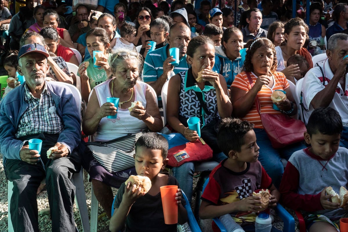 Colombia. Venezuelan migrants are given bread at a charitable feeding center