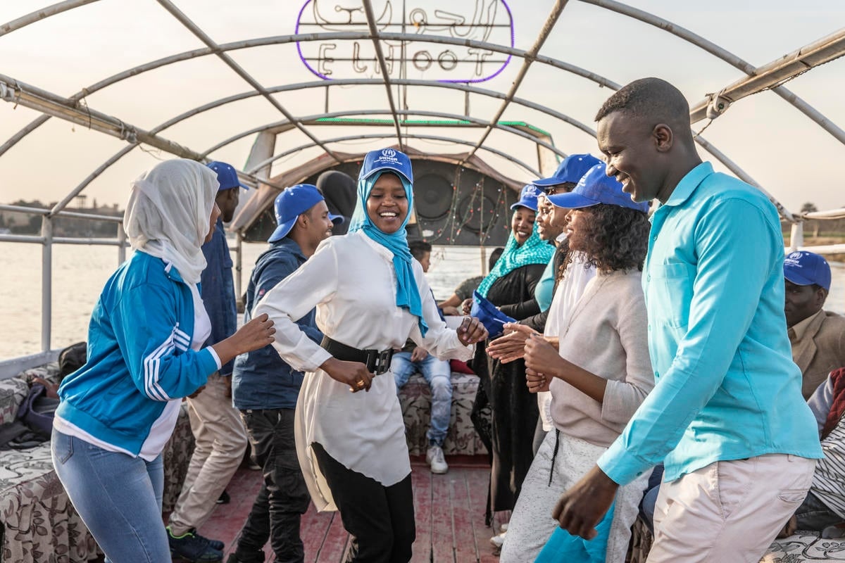Egypt. Refugees and locals clean the Nile together