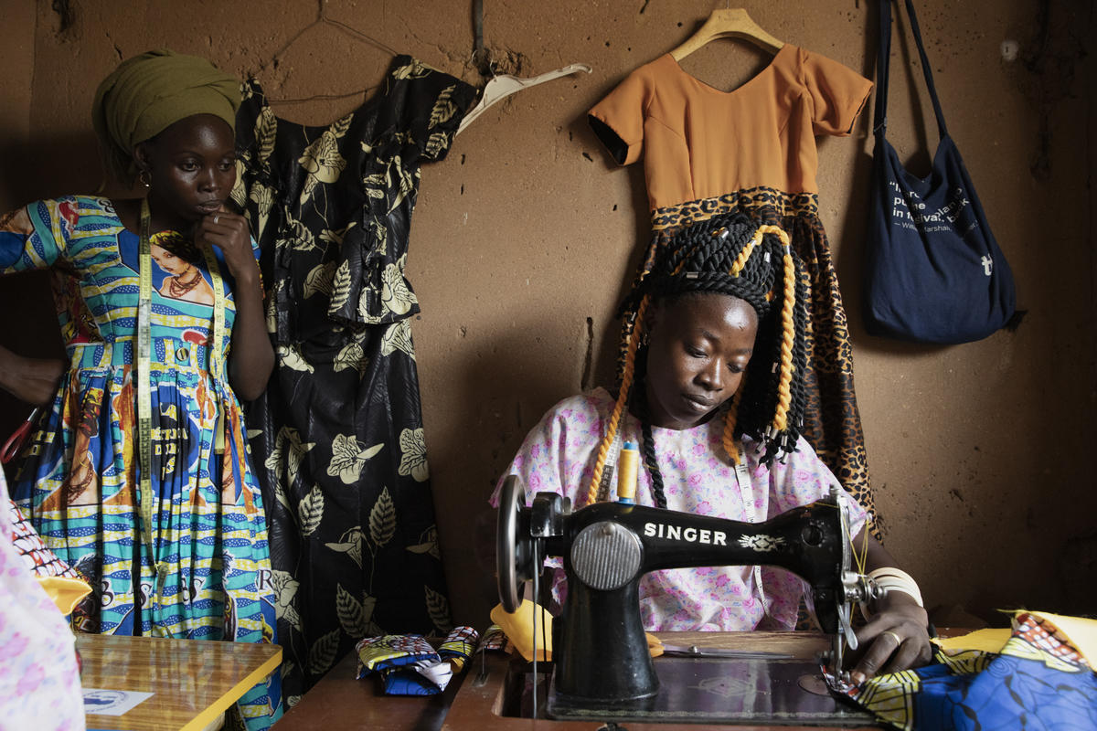 Central African Republic. A member of the "Standing Women" sews