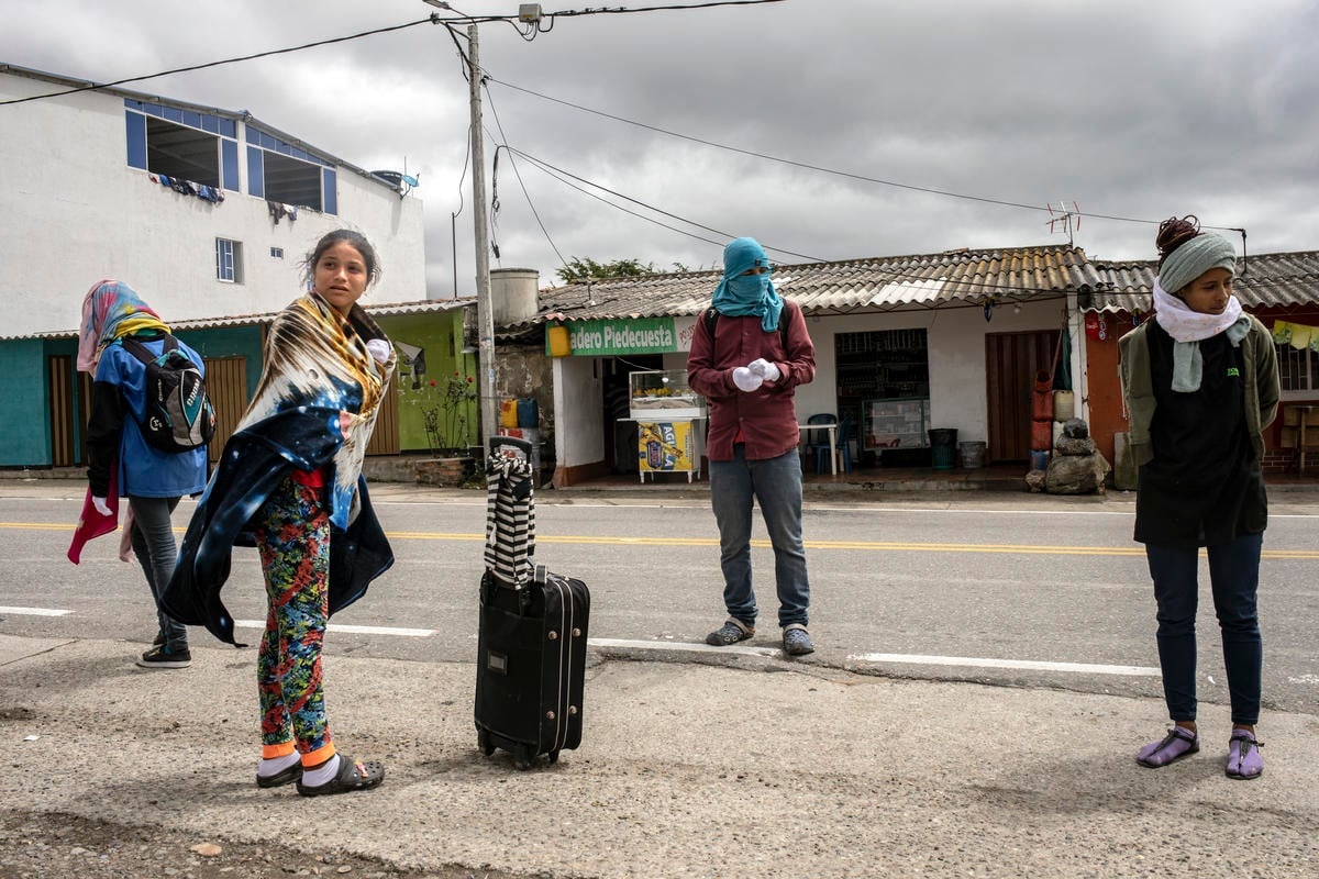 Colombia. Venezuelans get ready to walk across the mountain road