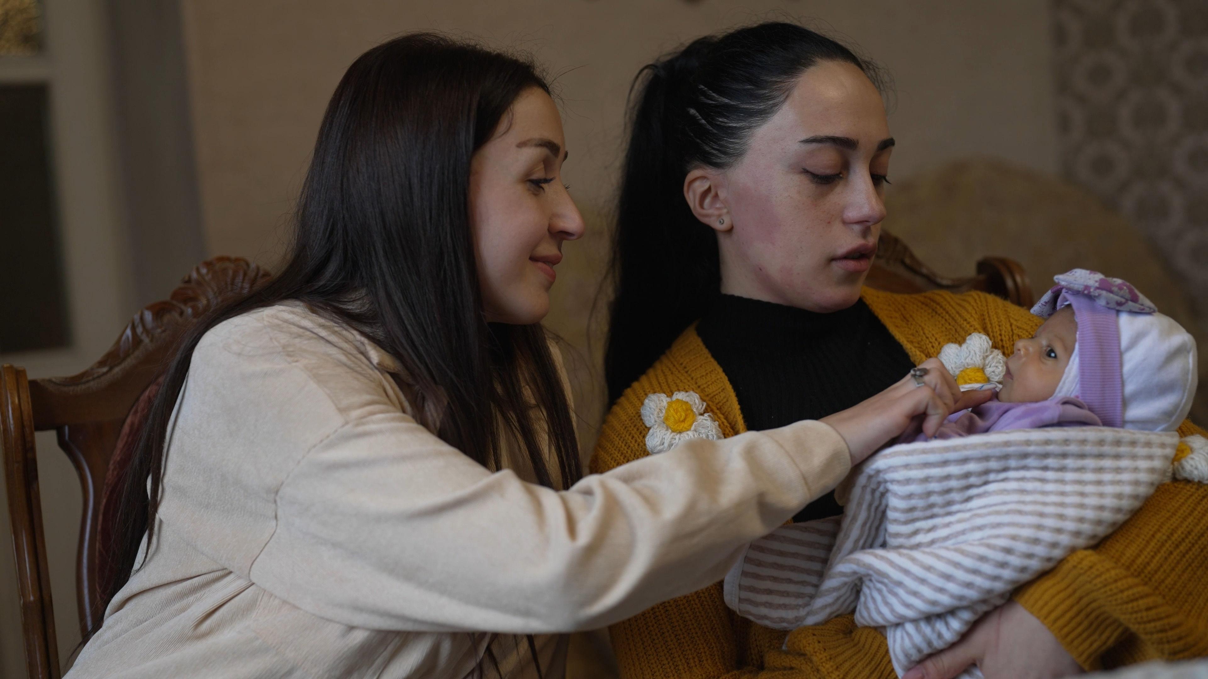 Karine and her sister in law Mariam with the newborn baby.