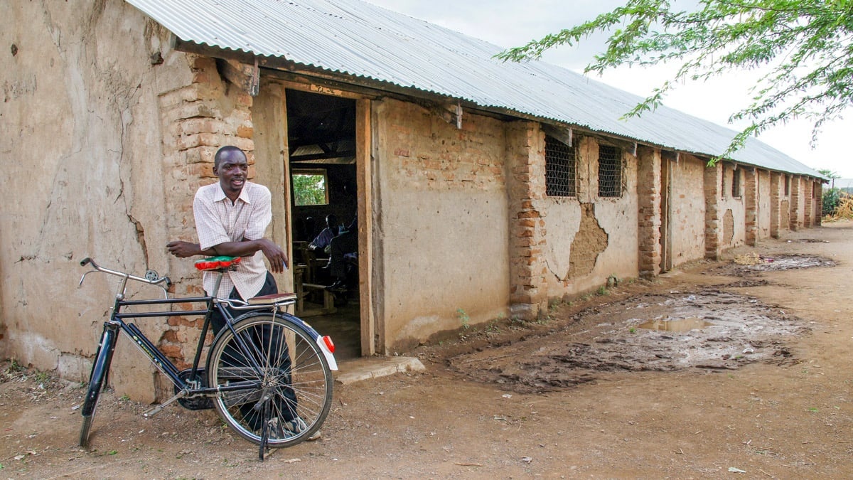 A pastor leans on his bicycle near the entrance of a local church in Kenya’s Kakuma refugee camp.