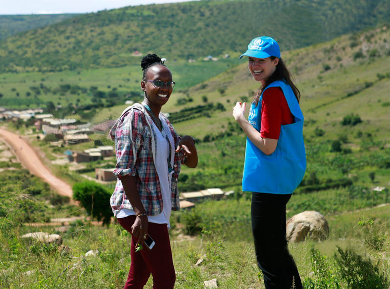 Jenna Froats with a UNHCR colleague in the hills of Uganda.