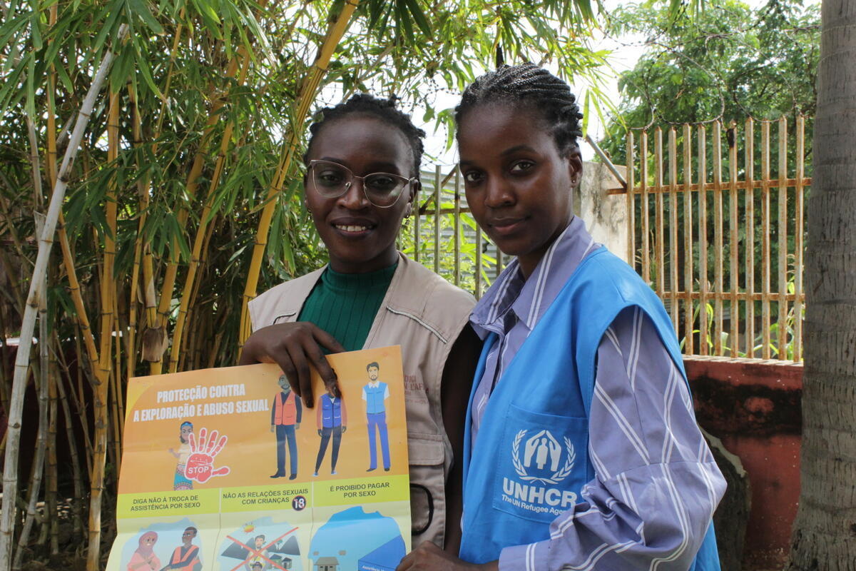 unhcr staff standing with Burundian refugee and psychologist