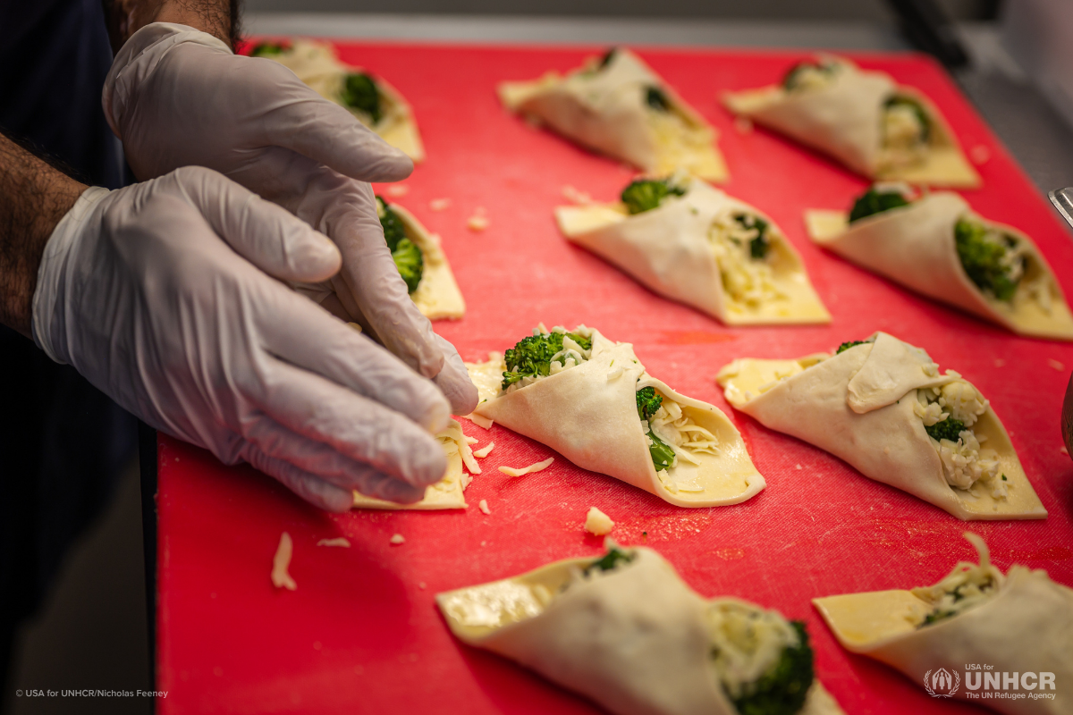 A student preparing food at Emma's Torch Cafe.