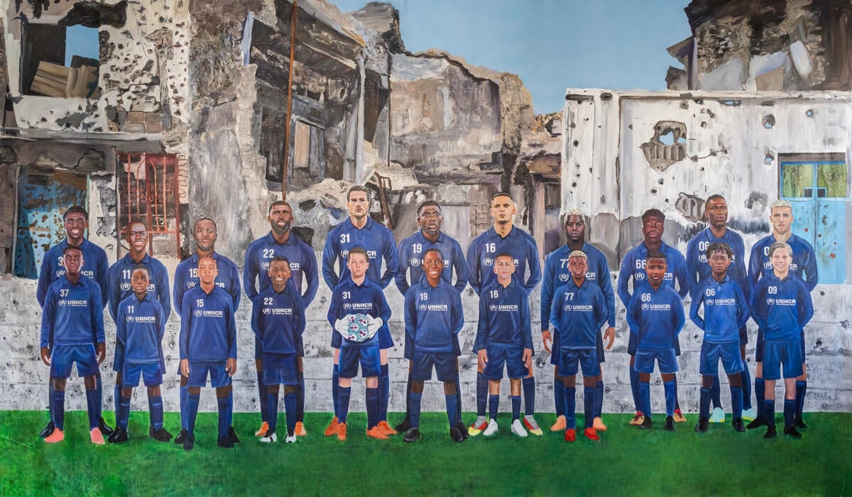 The art presents the following players: Alphonso Davies, Antonio Rüdiger, Eduardo Camavinga, Victor Moses, Asmir Begović, Mohamed Touré, Nestory Irankunda, Awer Mabil, Bernard Kamungo, Ali Al Hamadi and Ermedin Demirović.​
