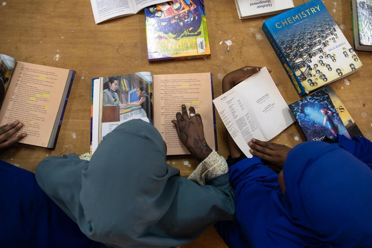 Students reading books on the floor