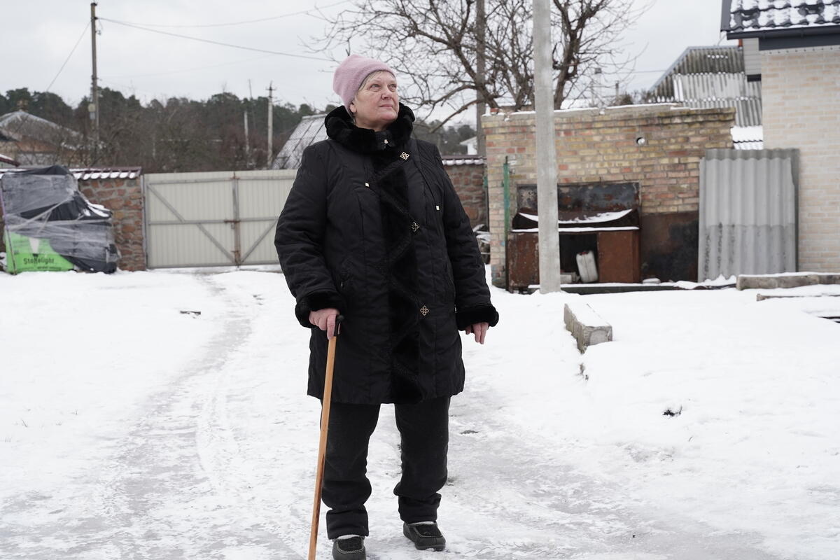 Lidiia, 69, is pictured on a snowy road in Horenka village.