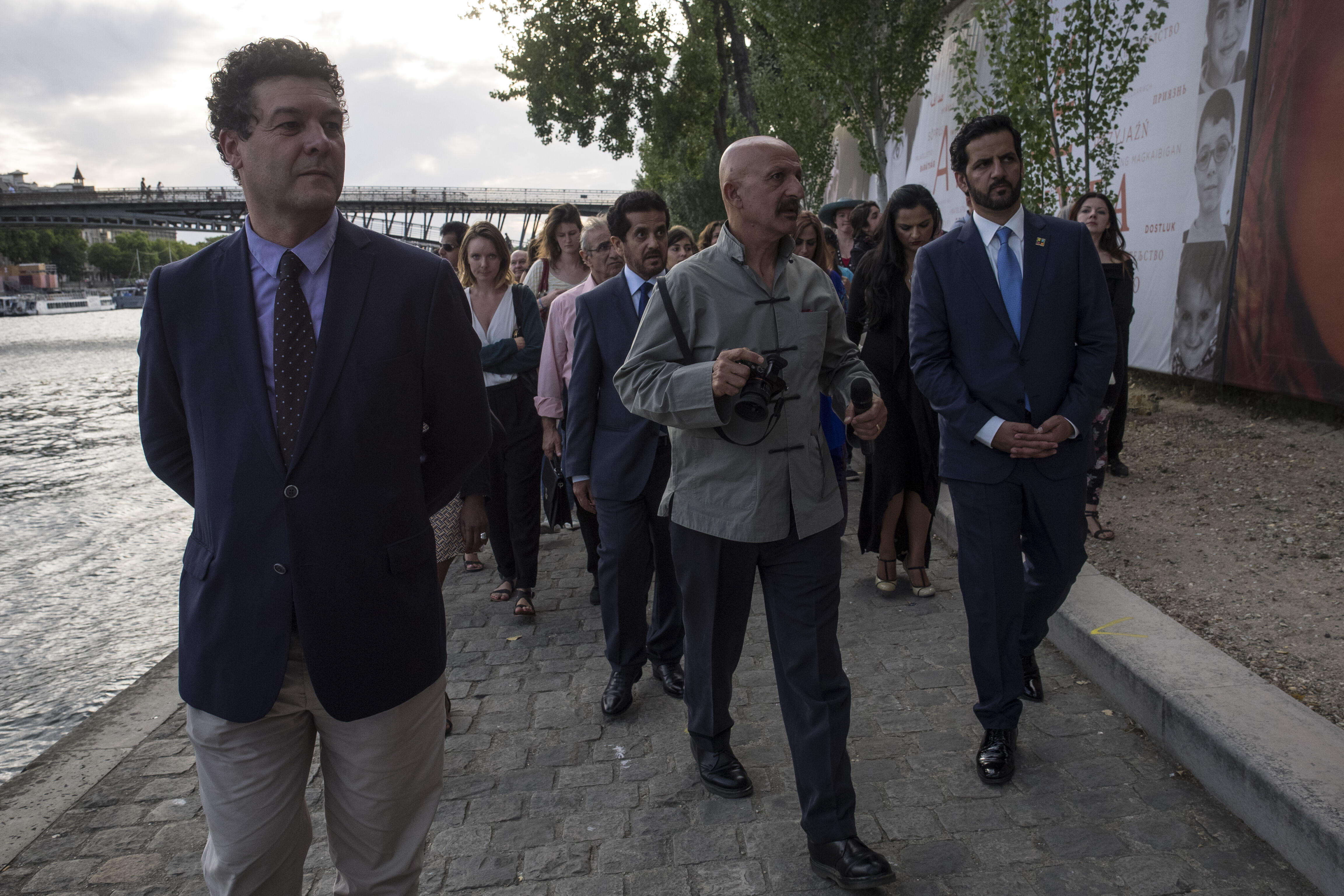 World-renowned photographer Reza presents his exhibition on the Seine's shore in Paris to HIPA's Secretary General Ali bin Thalith.