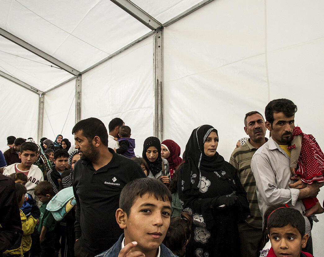 Syrian refugees queue up to be registered at the UNHCR registration offices in Amman, Jordan