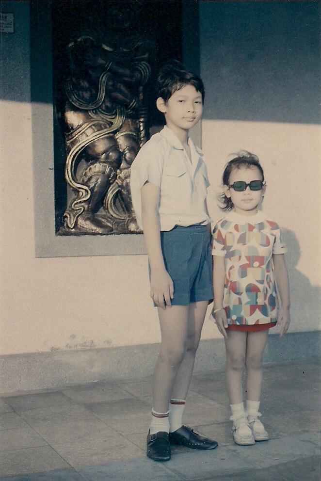 Two Vietnamese children pose for a photo in 1974 on a sidewalk in what was then Saigon, South Vietnam.