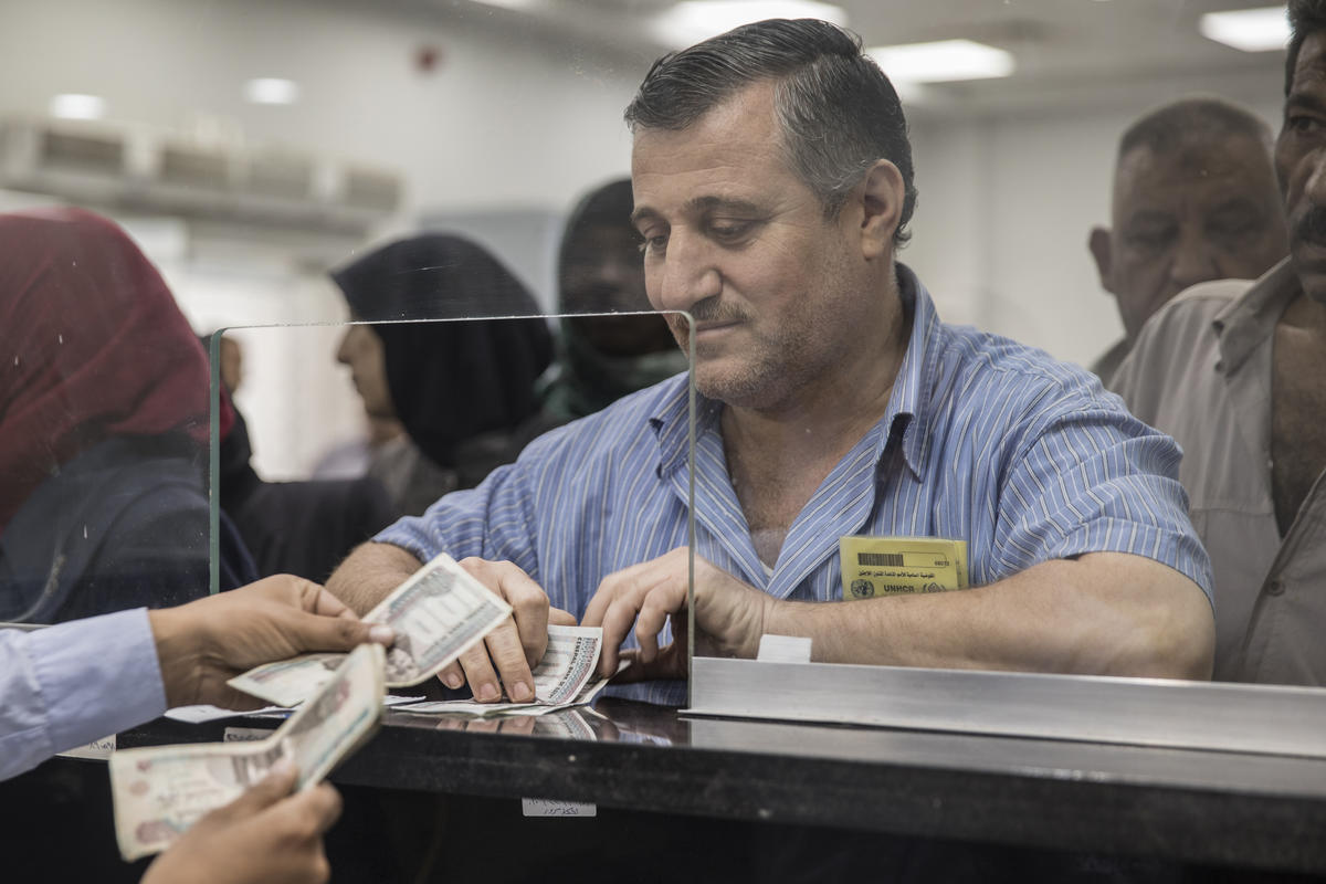 Egypt. Refugees receive UNHCR cash assistance