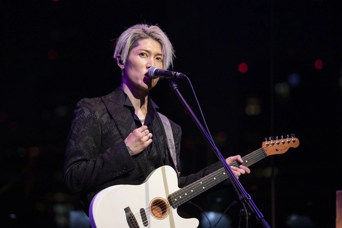 MIYAVI on stage with a guitar and microphone