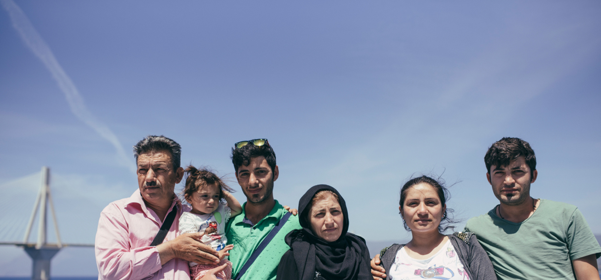 Greece, a family in the process of relocation aboard a small ferryboat.