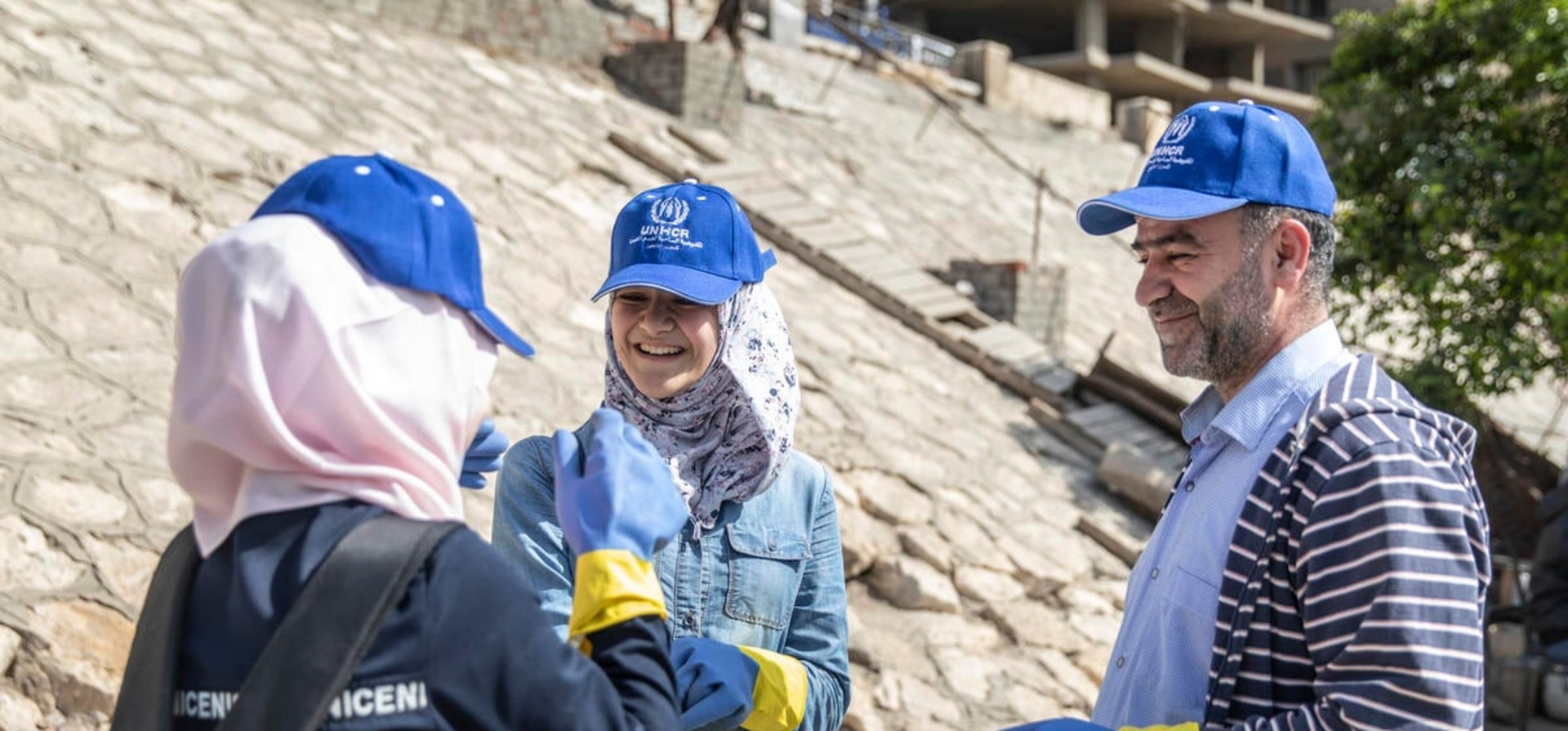 Egypt. Refugees and locals clean the Nile together