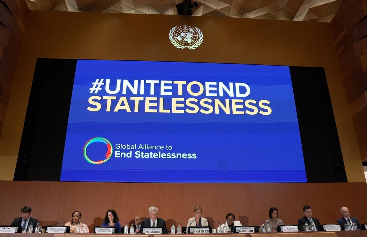 A large screen, over a panel of people sitting, reads "#UNITEDTOENDSTATELESSNESS Global Alliance to End Statelessness"