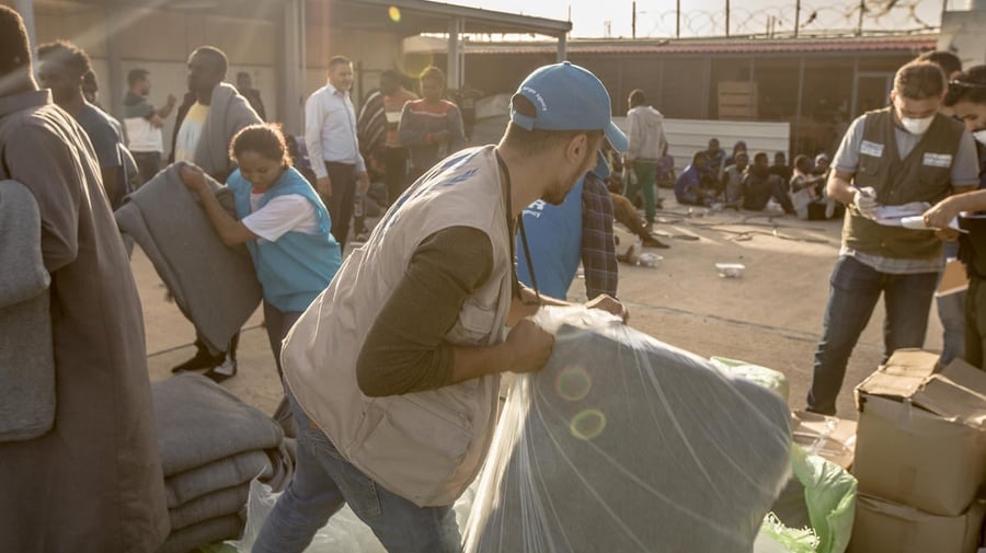 UNHCR staff distribute core relief items to refugees and migrants in Tripoli, Libya. 
