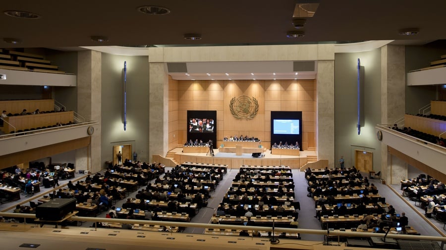 An assembly hall with the United Nations flag